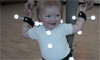 Toddler in motion capture suit. (Note: contemporary markers are much smaller than those shown here.)